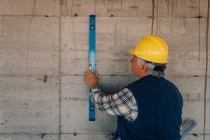 Crack-X team inspecting home foundation and basement for seasonal maintenance in New England Homes