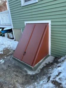 New waterproof bulkhead door installation with raised concrete areaway in Derry, NH