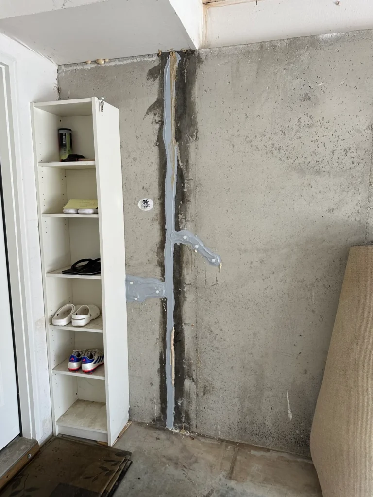 Foundation wall crack repair with epoxy injection sealing vertical basement crack in Windham NH