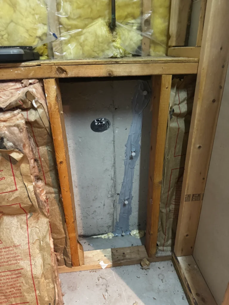 Repaired vertical foundation wall crack with epoxy injection inside a basement in Wilmington, MA
