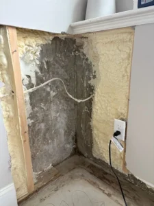 Foundation wall crack repair in Amesbury MA showing exposed basement wall and sealed crack repair system.