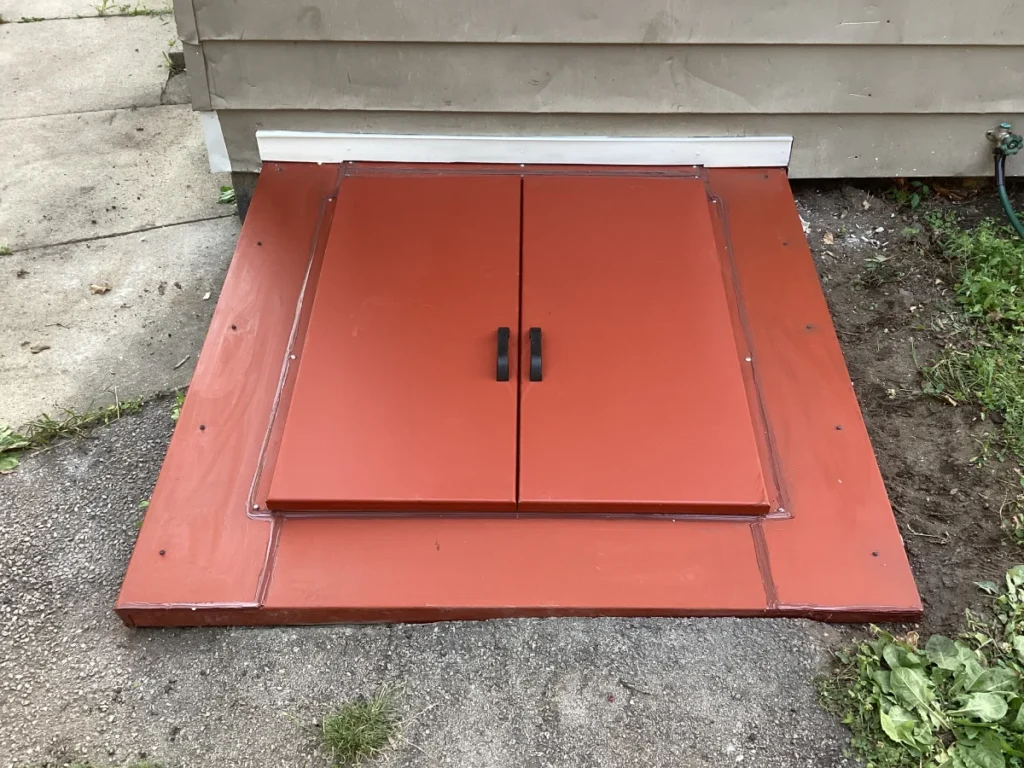 New bulkhead door replacement installed in Nashua, NH protecting basement entrance from water and weather damage.