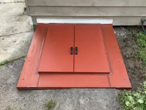 New bulkhead door replacement installed in Nashua, NH protecting basement entrance from water and weather damage.