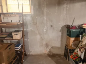 Before and after foundation wall crack repair in a Salem, MA basement, showing a professionally sealed diagonal concrete wall crack to prevent future water intrusion.