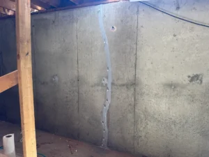 Foundation wall crack repair with epoxy injection and sealed tie rod penetrations in a basement in Billerica, MA.