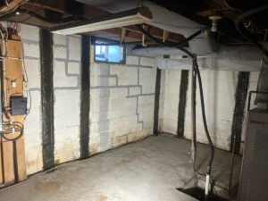 Basement foundation walls with repaired cracks and vertical reinforcement for structural support