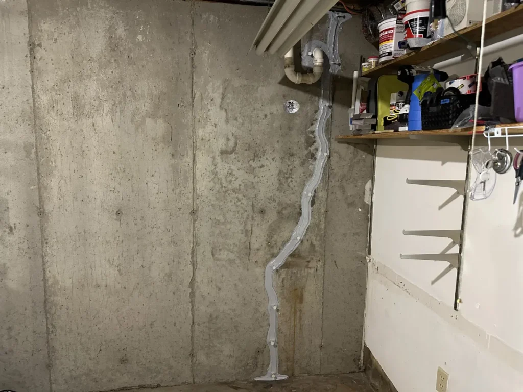 Completed pipe penetration and foundation wall crack repair in a Hampstead, NH basement