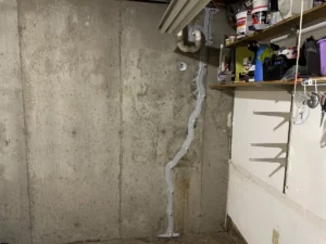 Completed pipe penetration and foundation wall crack repair in a Hampstead, NH basement