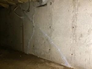 Foundation wall crack repair with injection ports and sealant in a Portsmouth, NH crawlspace.
