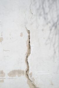 Vertical foundation wall crack showing damaged concrete before foundation crack repair in New England