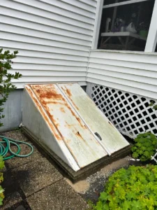 Old rusted basement bulkhead door before replacement in Methuen, MA