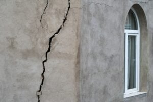 Large vertical foundation crack running through the exterior wall of a home