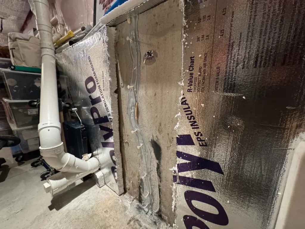 Foundation wall crack injection repair with sealed injection ports in a Newburyport, MA basement.